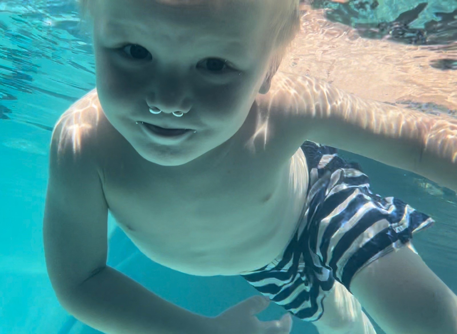 Infant swim class with parent and instructor
